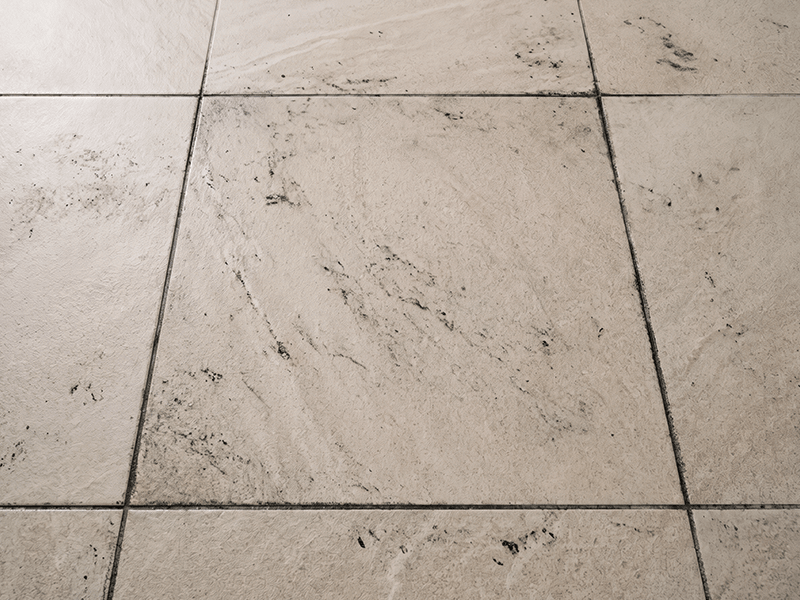 Original seller before image showing dark dirt marks and stained grout between floor tiles